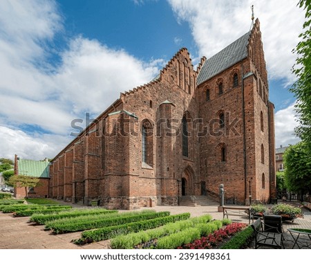 The exterior of St. Mary's Church with beautiful green courtyard. Helsingborg, Sweden. Royalty-Free Stock Photo #2391498361