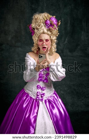 Shocked woman dressed like classic historical character, in old-fashioned dress and looking at mobile phone against vintage background. Concept of technology, news, shopping, sales, delivery, online. Royalty-Free Stock Photo #2391498829