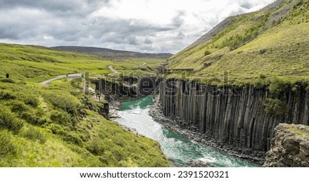 Jokla River cuts through the Studlagil canyon and passes by the hexagonal basalt columns caused by lava flows in Northeast Iceland, Jokuldalur Valley, Europe Royalty-Free Stock Photo #2391520321