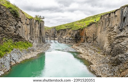 Jokla River cuts through the Studlagil canyon and passes by the hexagonal basalt columns caused by lava flows in Northeast Iceland, Jokuldalur Valley, Europe Royalty-Free Stock Photo #2391520351