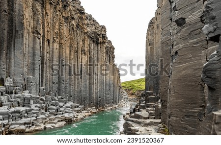 Jokla River cuts through the Studlagil canyon and passes by the hexagonal basalt columns caused by lava flows in Northeast Iceland, Jokuldalur Valley, Europe Royalty-Free Stock Photo #2391520367