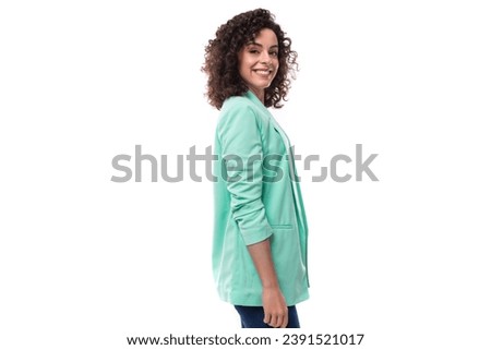 pretty smiling young brunette curly businesswoman dressed in a blue jacket