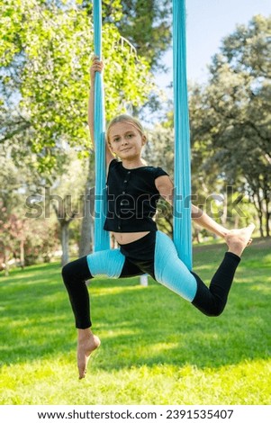 School girl yoga exercise in park outdoor. Child smiling looking at camera. Healthy mental growing for pre adolescent children. Harmony in puberty. Self confidence and physical activity Royalty-Free Stock Photo #2391535407