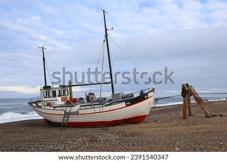Old wooden fishing boat in Lild Strand, Jutland, Denmark Royalty-Free Stock Photo #2391540347