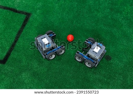 Automated cars and playing football with a ball on radio control. Robotics Royalty-Free Stock Photo #2391550723