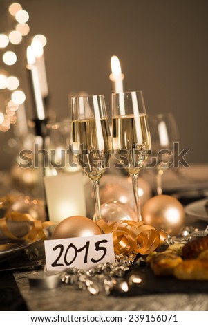 2015 new years eve party table with champagne flute ribbon and glitter 