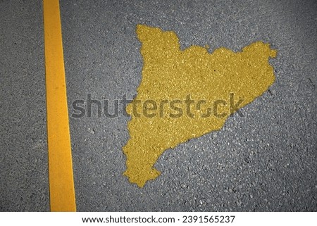 yellow map of catalonia country on asphalt road near yellow line. concept