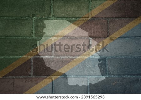 painted map and flag of tanzania on a old brick wall