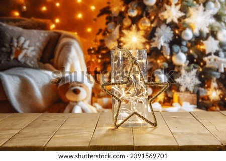 Yellow old wooden table and free space for your decoration. Blurred home interior with christmas tree. Empty space for your products. Mockup background and magic december time. Natural light. 