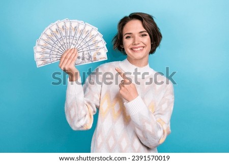 Photo portrait of attractive young woman point money dollars banknotes dressed stylish white clothes isolated on blue color background