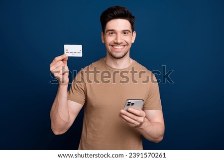 Photo of attractive stylish man showing debit bank card cashless transaction payment network isolated on dark blue color background