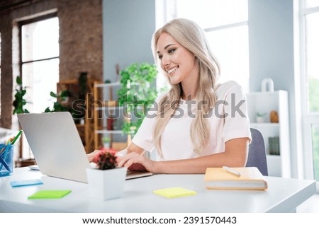 Photo of pretty cute joyful lady sitting home writing answer resume cv working remote in modern house indoors