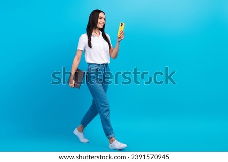 Full length photo of confident busy lady wear white shirt walking working modern devices empty space isolated blue color background