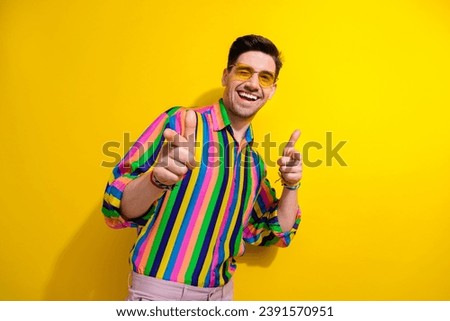 Photo of trendy guy at retro theme party wearing old clothes with sunglasses point fingers you flirting isolated on yellow color background Royalty-Free Stock Photo #2391570951