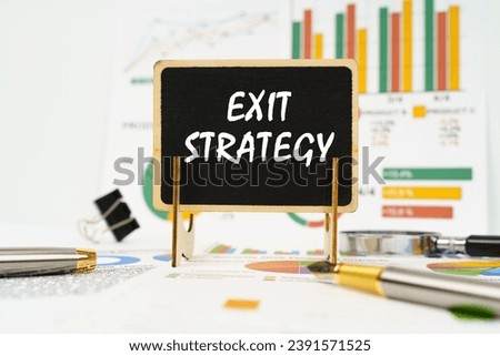 Business concept. Against the background of business graphs, a board with the inscription - Exit Strategy