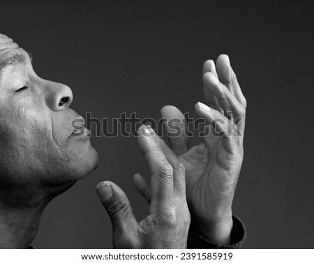 praying to God with hands together on black background with people stock image stock photo