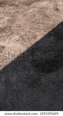 Orange concrete surface, sunlight, rough stone pattern on the floor, steel frame.