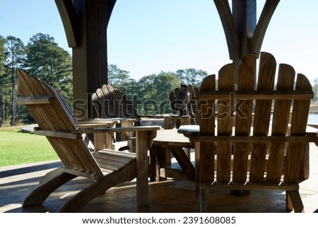 Wooden outdoor furniture for leisure time on a covered patio at a lake house