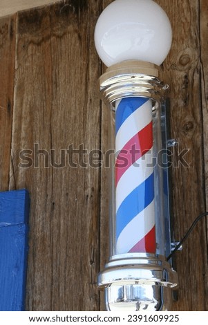 A classic barber pole sign for a barbershop.