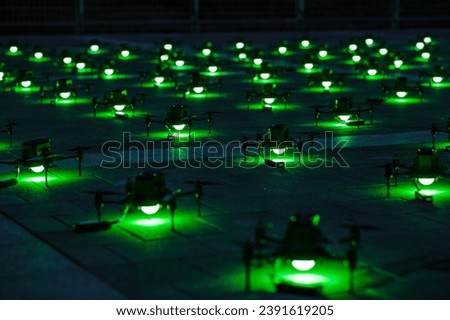 A mesmerizing drone show paints the night sky with synchronized lights and patterns. A symphony of technology and creativity, captivating audiences with aerial choreography. Royalty-Free Stock Photo #2391619205