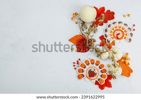 Autumn table setting. Thanksgiving cutlery, traditional fall decor, flat lay. Festive cozy mood, handmade crocheted turkeys and leaves, top view