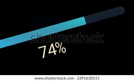 Simple generic blue loading downloading uploading or system update progress bar object detail, display monitor extreme closeup macro, nobody. Percentage going up finishing transfer updating os concept Royalty-Free Stock Photo #2391630115