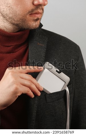 Businessman in a jacket and blank id card . Business concept