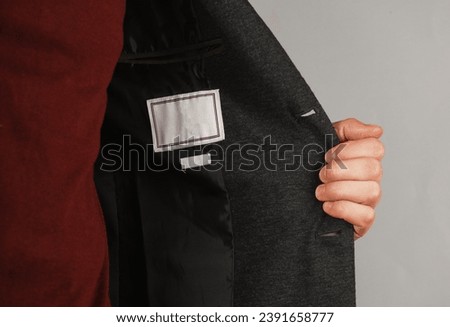 Jacket with a sewn-in tag inside for a man Royalty-Free Stock Photo #2391658777