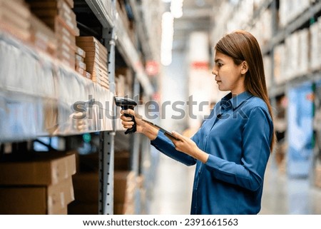 Women worker use scanner to check and scan barcodes of stock inventory on shelves to keep storage in a system, Smart warehouse management system, Supply chain and logistic network technology concept. Royalty-Free Stock Photo #2391661563