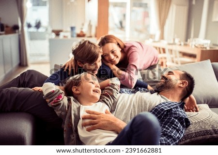 Joyful Parents Having Playtime with Children at Home Royalty-Free Stock Photo #2391662881