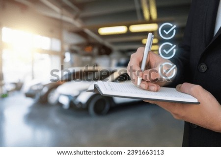 Concept of filling out car insurance in a garage. The insurer fills out insurance for the car.