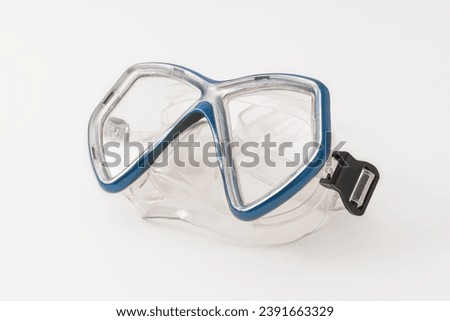 A pair of blue diving goggles, snorkeling mask isolated on white background, perspective view