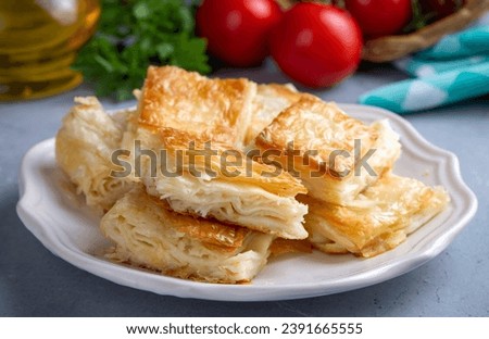 Delicious Turkish Tray pastry, Su boregi with cheese. Adana borek. Royalty-Free Stock Photo #2391665555