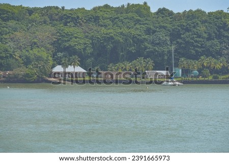 French Overseas Territory, French Guiana, Salvation Islands. View of Devil's Island from Ile Royale, home to infamous prison. Royalty-Free Stock Photo #2391665973