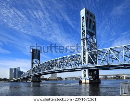 The Main Street Bridge in Jacksonville, Florida. The bridge uses trusses to lift up vertically, keeping it parallel while allowing ships to pass below on the St. Johns River. 