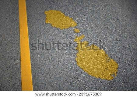 yellow map of malta country on asphalt road near yellow line. concept