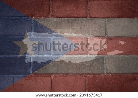painted map and flag of puerto rico on a old brick wall