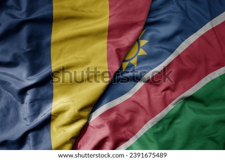 big waving national colorful flag of namibia and national flag of chad . macro