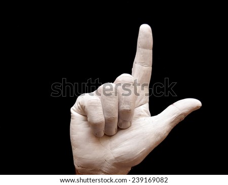 Sign Language American alphabet with hands painted white over black background letter l
