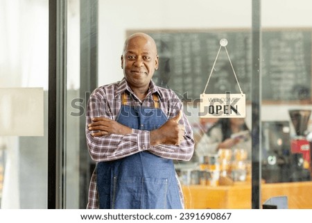 Financial freedom of small business Shot of a cheerful senior man smiling happily holding up an open sign posing at his own cafe in front of the door senior male standing his small business sme. Royalty-Free Stock Photo #2391690867