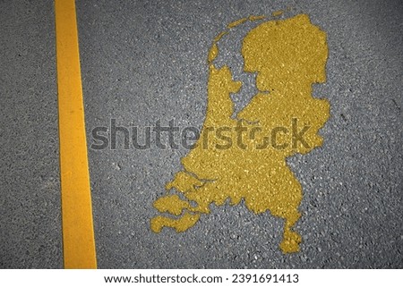 yellow map of netherlands country on asphalt road near yellow line. concept