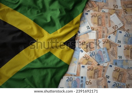big colorful waving national flag of jamaica on a euro money background. finance concept