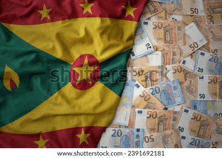 big colorful waving national flag of grenada on a euro money background. finance concept