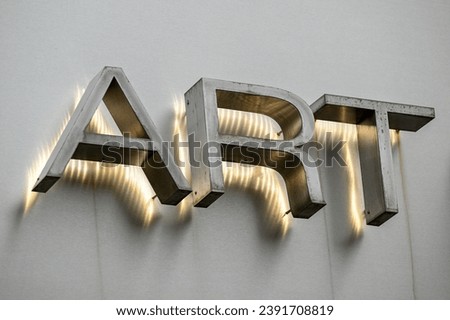 glowing channel letters spelling the word art on building