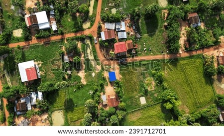 An aerial view of a rural area with houses and trees. Beautiful picture of landscape.