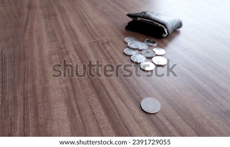 Pile of Indonesian rupiah coins. some coins came out of the wallet.   Finance concept photograph