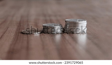 Pile of Indonesian rupiah coins. Silver Coin stacks. Finance concept photograph