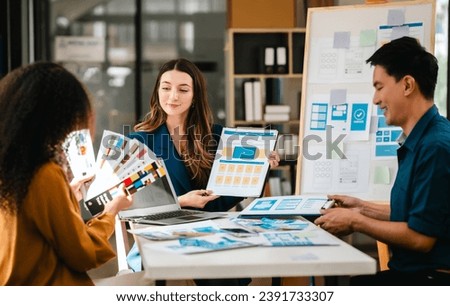 diverse team of professionals engaged in a website graphic design board meeting, sharing opinions on UX and UI design elements. Asian man, African American people, black, afro, caucasian female