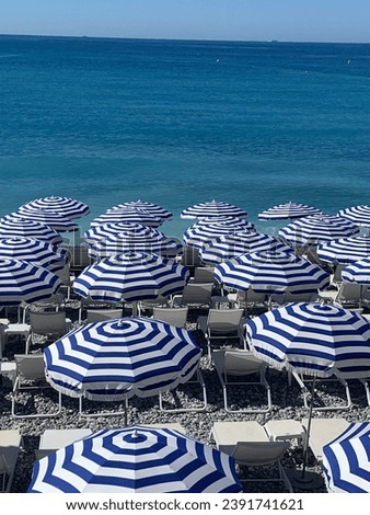 Promenade des Anglais on the beach in Nice, southern France, embracing the Mediterranean Sea Royalty-Free Stock Photo #2391741621