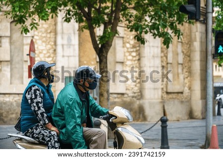 Side view of a people on a motorcycle scooter stop at crosswalk in Hanoi city, Vietnam